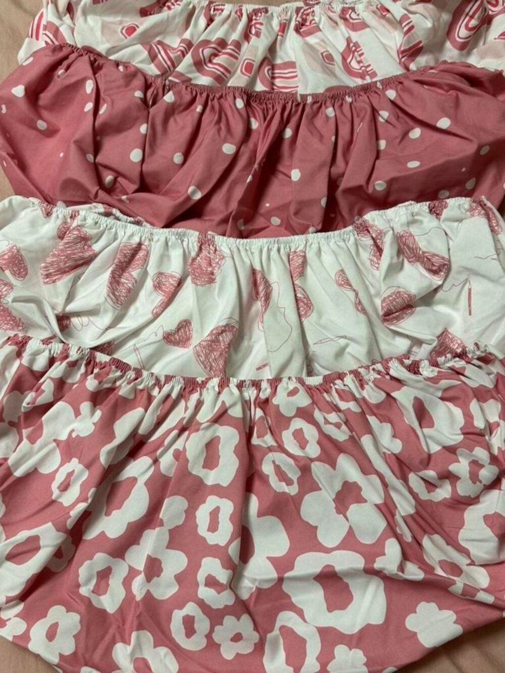 Set of 4 baby girl multi patterned bassinet sheets.